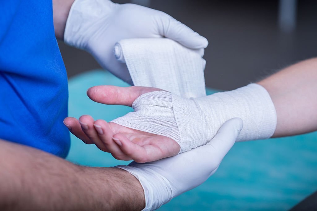 Frozen Shoulder Close-up of male doctor bandaging a hand